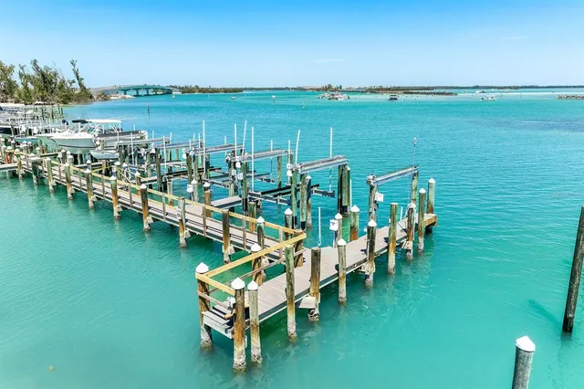 a view of a lake with lawn chairs