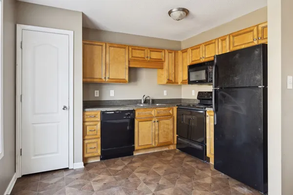 a kitchen with a refrigerator sink and stove