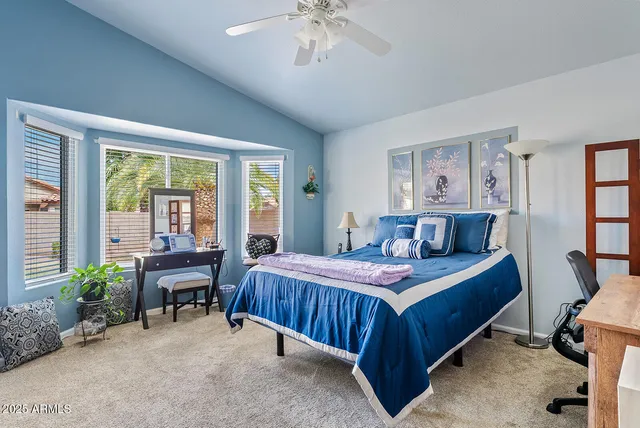 a bedroom with a bed and a table