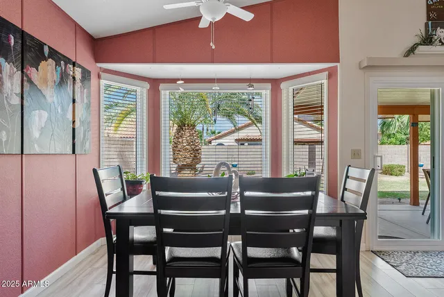 a dining room with furniture and window