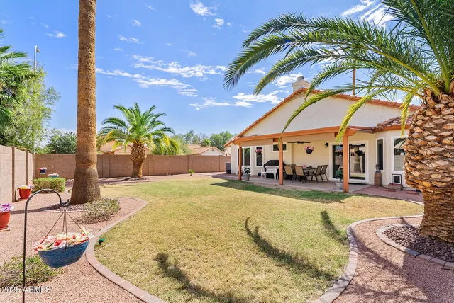 a swimming pool with outdoor seating and yard