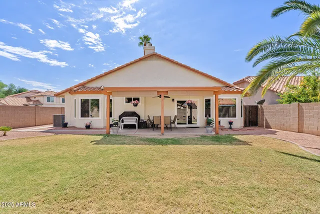 a view of a house with swimming pool and a yard