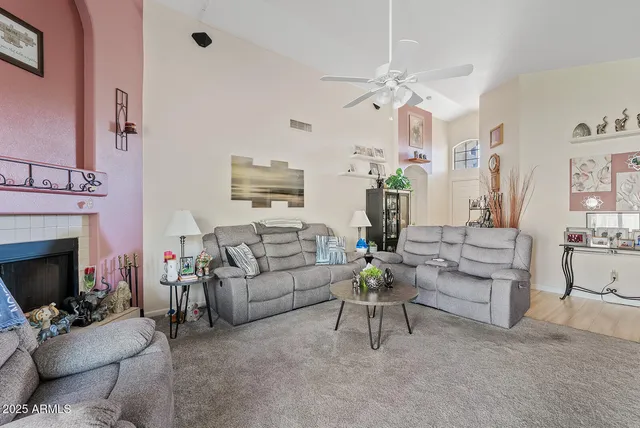 a living room with furniture a fireplace and a flat screen tv