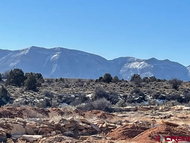 a view of a house with a mountain and mountains in the background