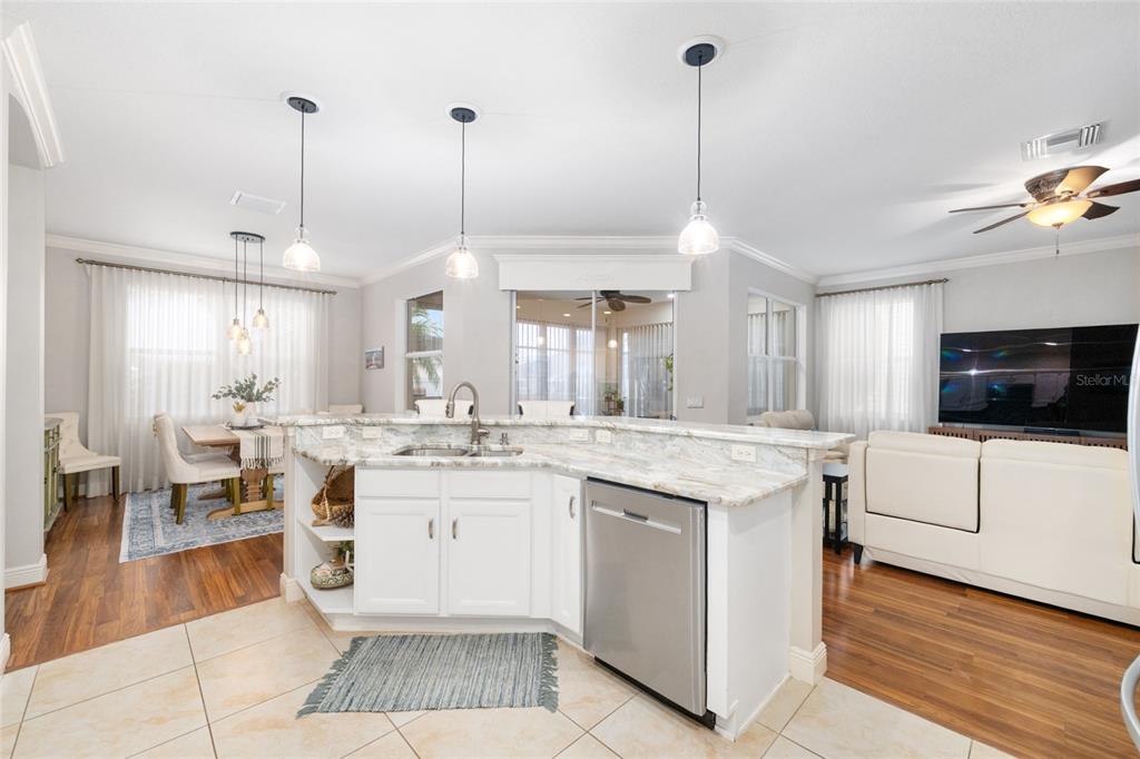 879 Chapman Loop The Villages, FL 32162 - Photo 11 of 34 a large kitchen with kitchen island a sink a counter space appliances and cabinets