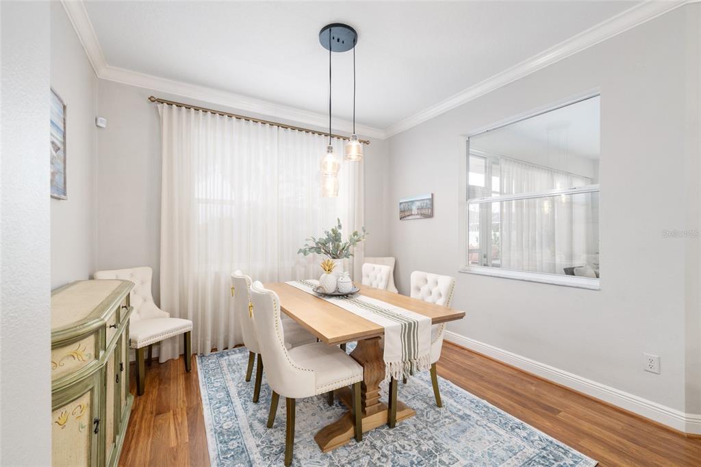 879 Chapman Loop The Villages, FL 32162 - Photo 12 of 34 a view of a dining room with furniture window and wooden floor