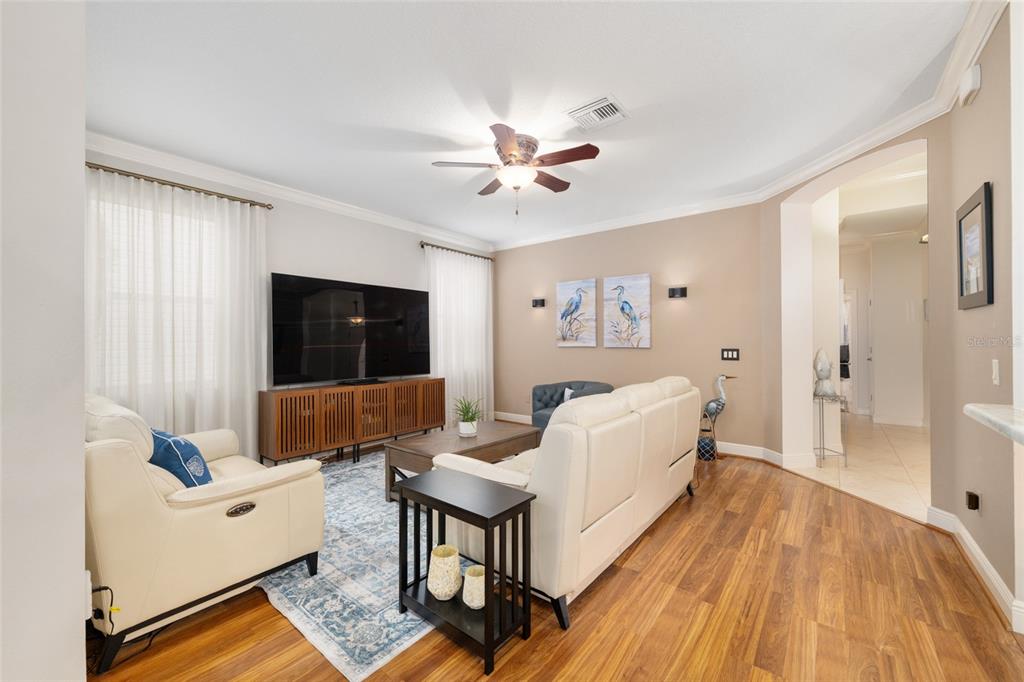 879 Chapman Loop The Villages, FL 32162 - Photo 16 of 34 a living room with furniture and a flat screen tv