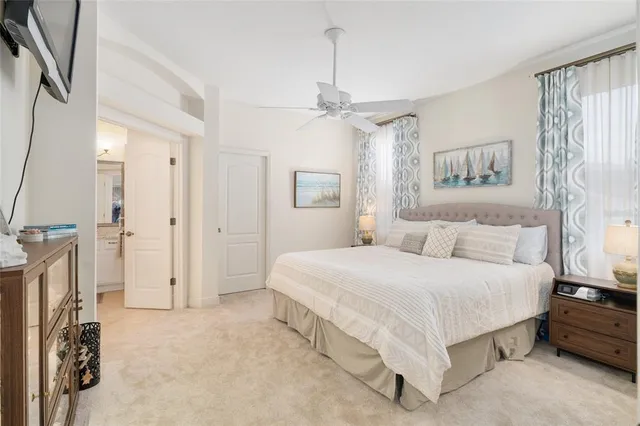 a spacious bedroom with a bed and a chandelier