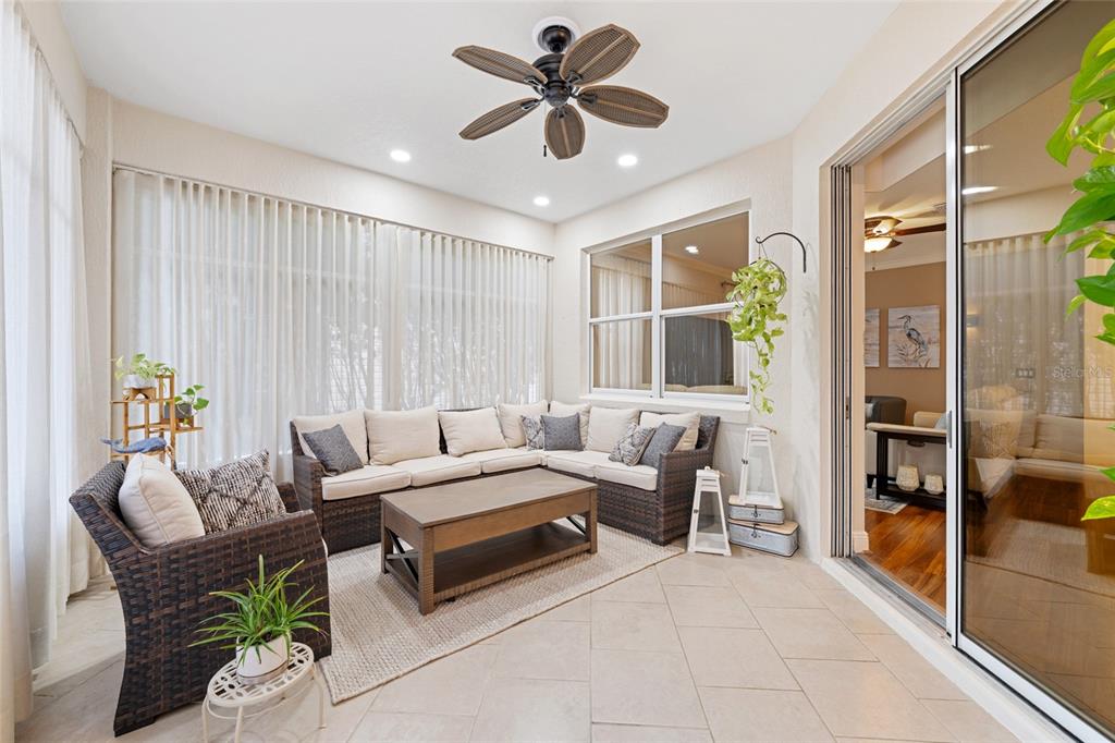 879 Chapman Loop The Villages, FL 32162 - Photo 30 of 34 a living room with furniture and a chandelier