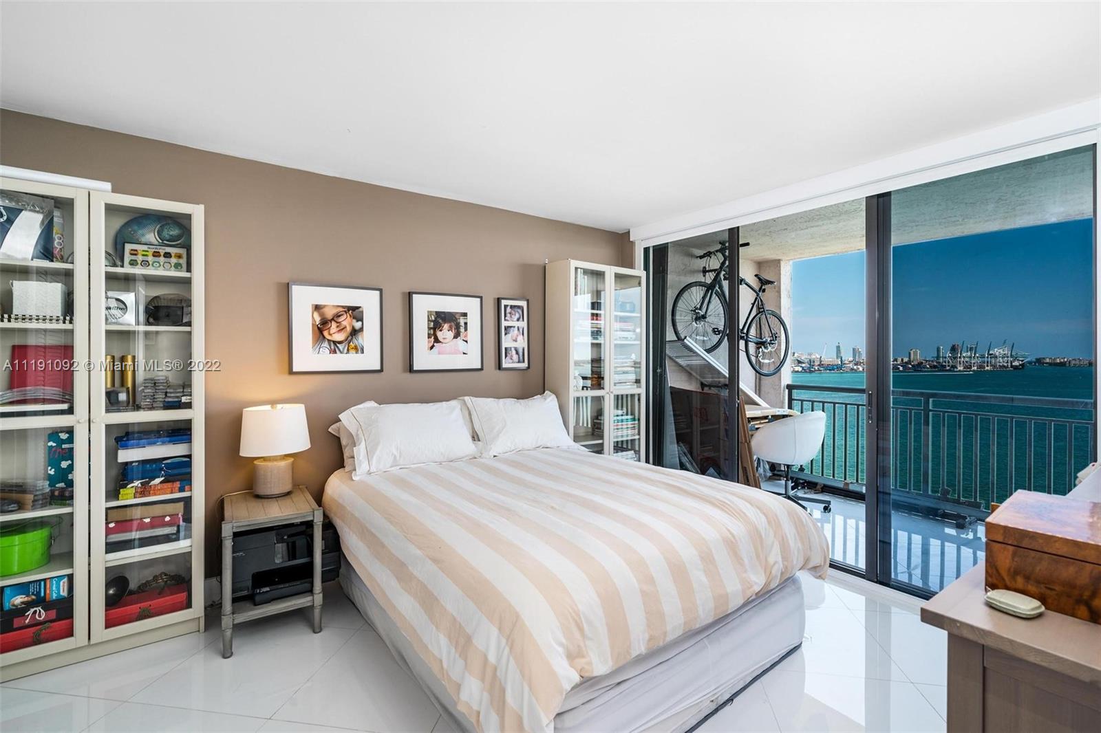 540 Brickell Key Drive, Unit 1427 Miami, FL 33131 - Photo 11 of 16 a bedroom with a bed and a closet