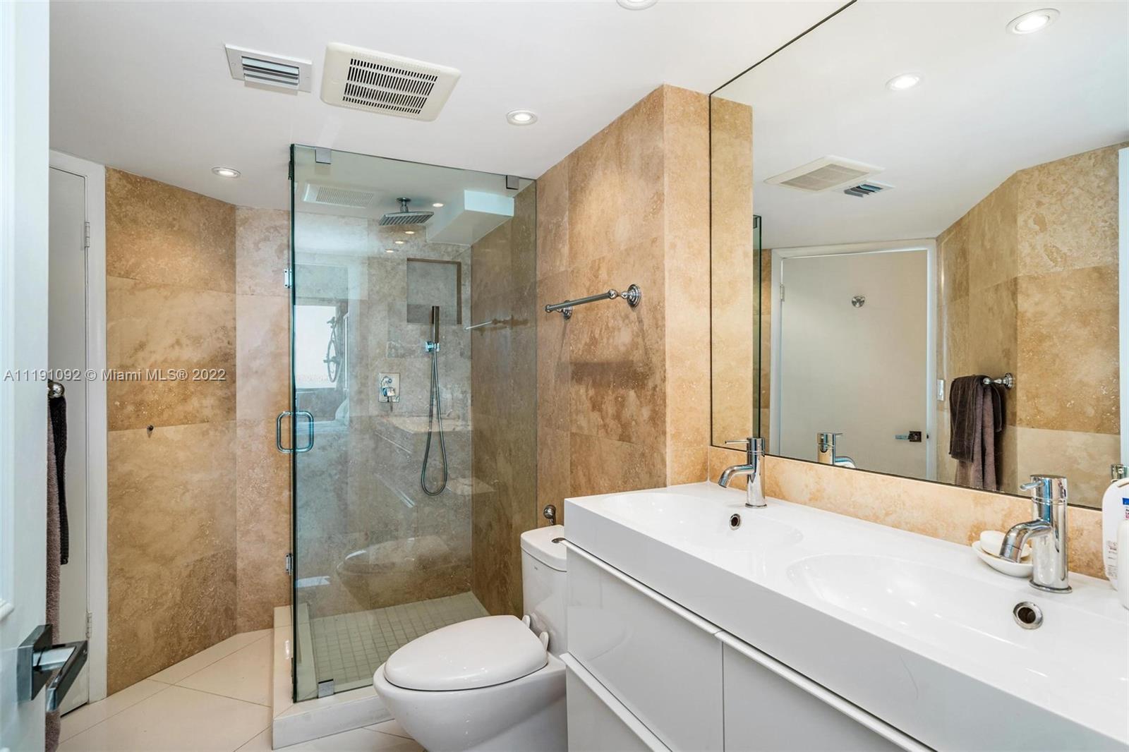 540 Brickell Key Drive, Unit 1427 Miami, FL 33131 - Photo 12 of 16 a bathroom with a sink a toilet and shower