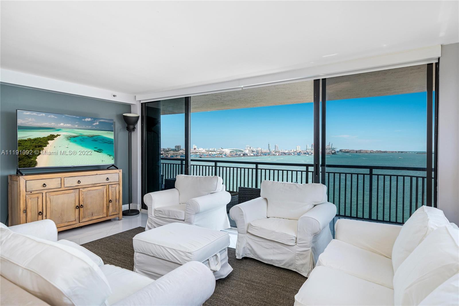 540 Brickell Key Drive, Unit 1427 Miami, FL 33131 - Photo 4 of 16 a living room with furniture and a large window