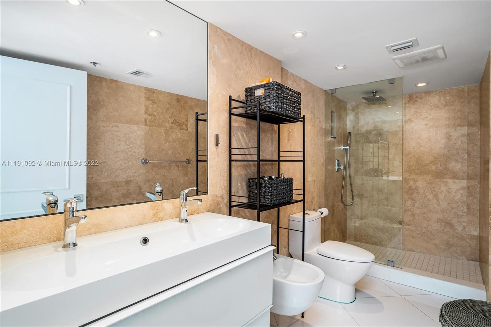 540 Brickell Key Drive, Unit 1427 Miami, FL 33131 - Photo 9 of 16 a bathroom with a sink a toilet and shower