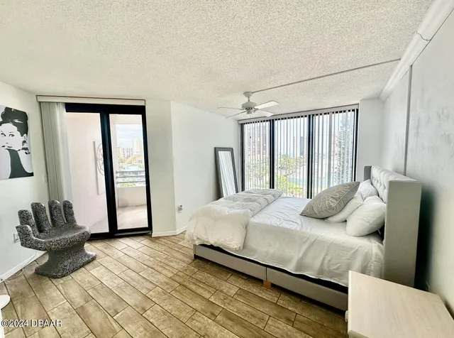 a bedroom with a bed and a large window