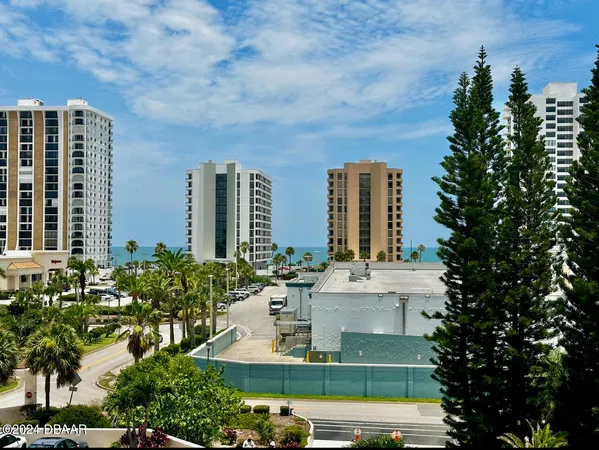 a view of a building with a garden and plants