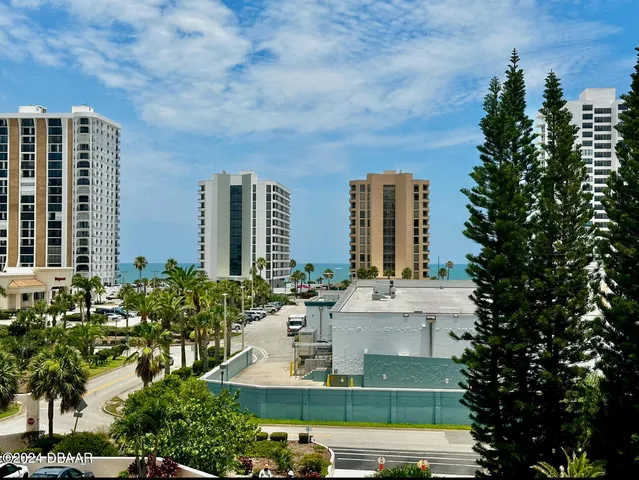 a view of a building with a garden and plants