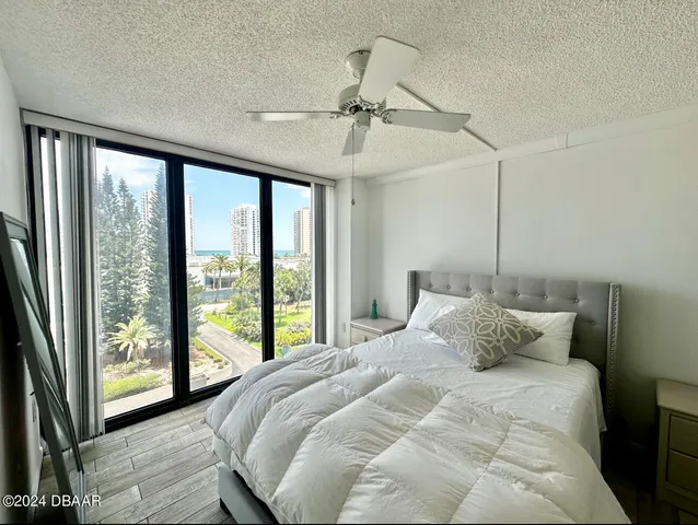 a bedroom with a large bed and a large window