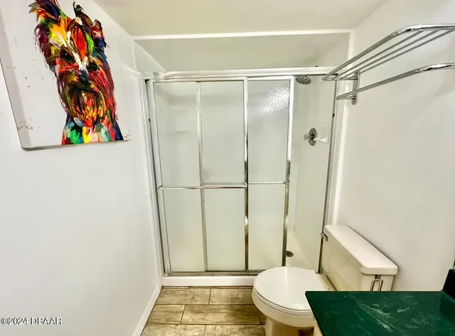 a bathroom with a toilet and a shower curtain