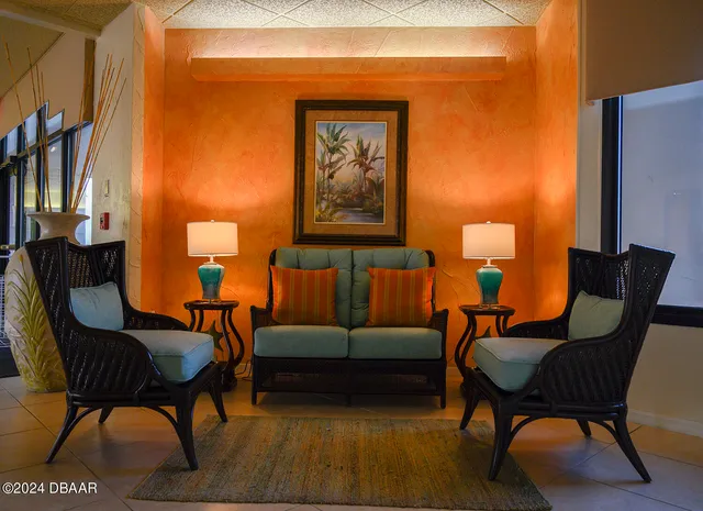 a living room with furniture and a lamp