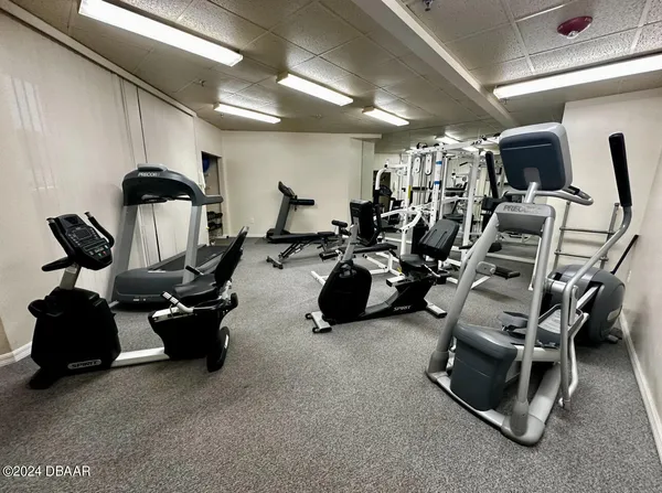 a room with gym equipment and mirror