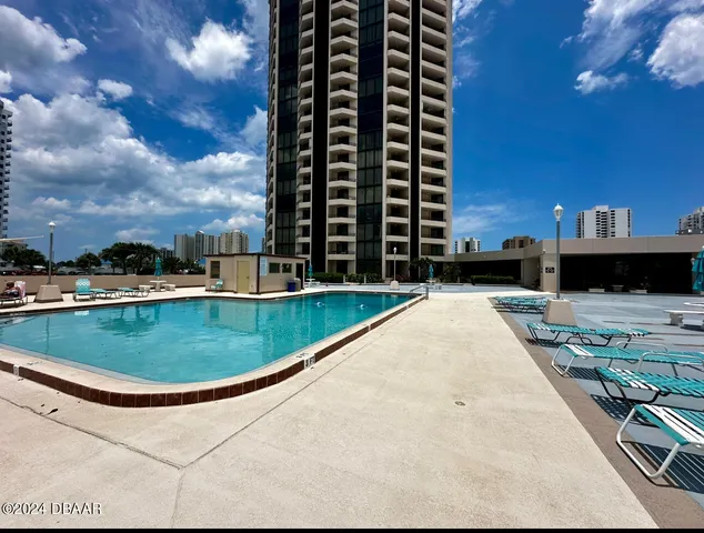 a view of a swimming pool with a yard