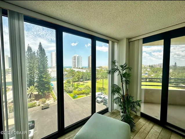 a room with large windows and furniture