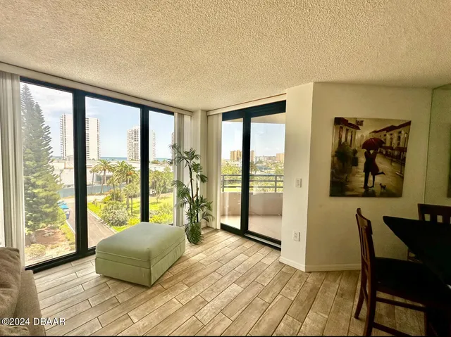 a bedroom with a large window and a bed
