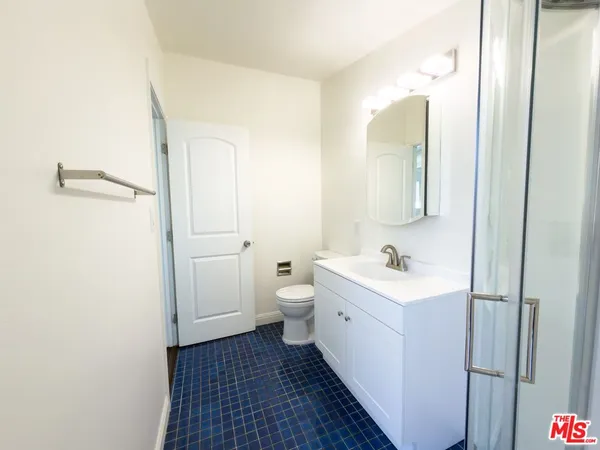 a bathroom with a sink a toilet and a mirror