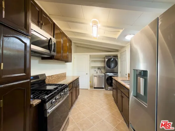 a kitchen with stainless steel appliances granite countertop a stove and a refrigerator