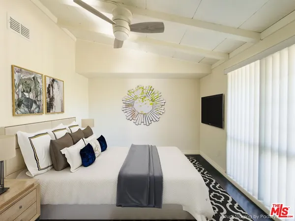 a bedroom with bed and a window