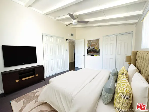 a bedroom with a bed and a television