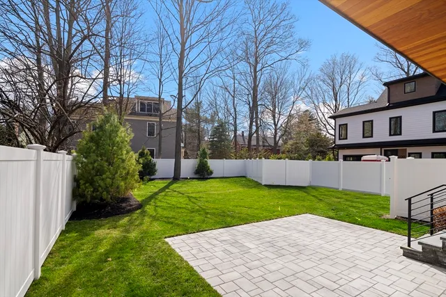 a view of a backyard with a white house