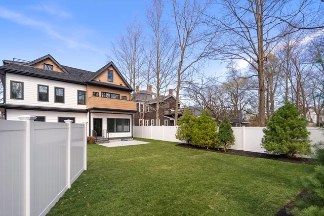 a front view of a house with a yard and trees