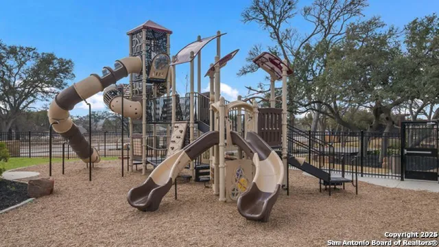 an aerial view of a house with swimming pool and a yard