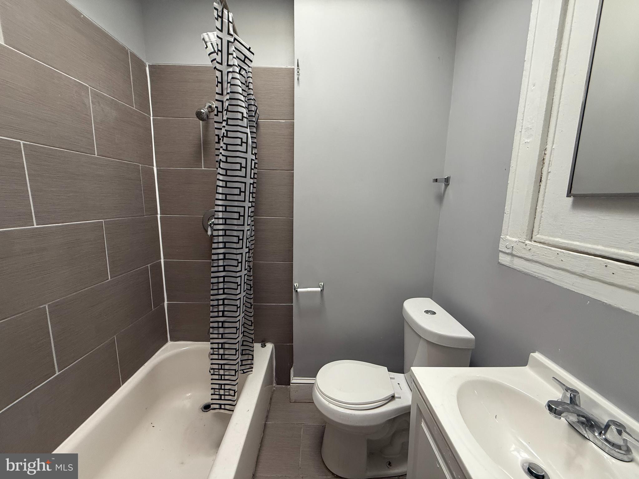 5313 Hamlin Avenue Baltimore, MD 21215 - Photo 11 of 14 a bathroom with a sink toilet and shower