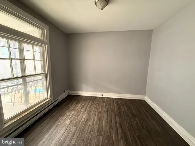 a view of a room with wooden floor and window