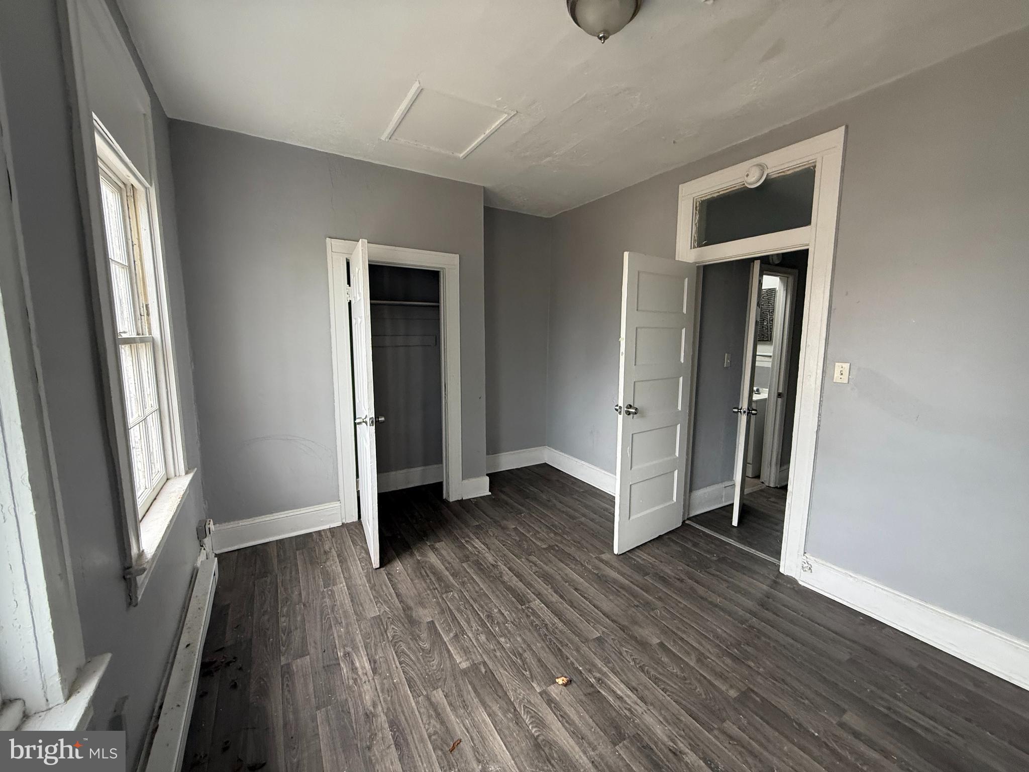 5313 Hamlin Avenue Baltimore, MD 21215 - Photo 10 of 14 an empty room with wooden floor and a window