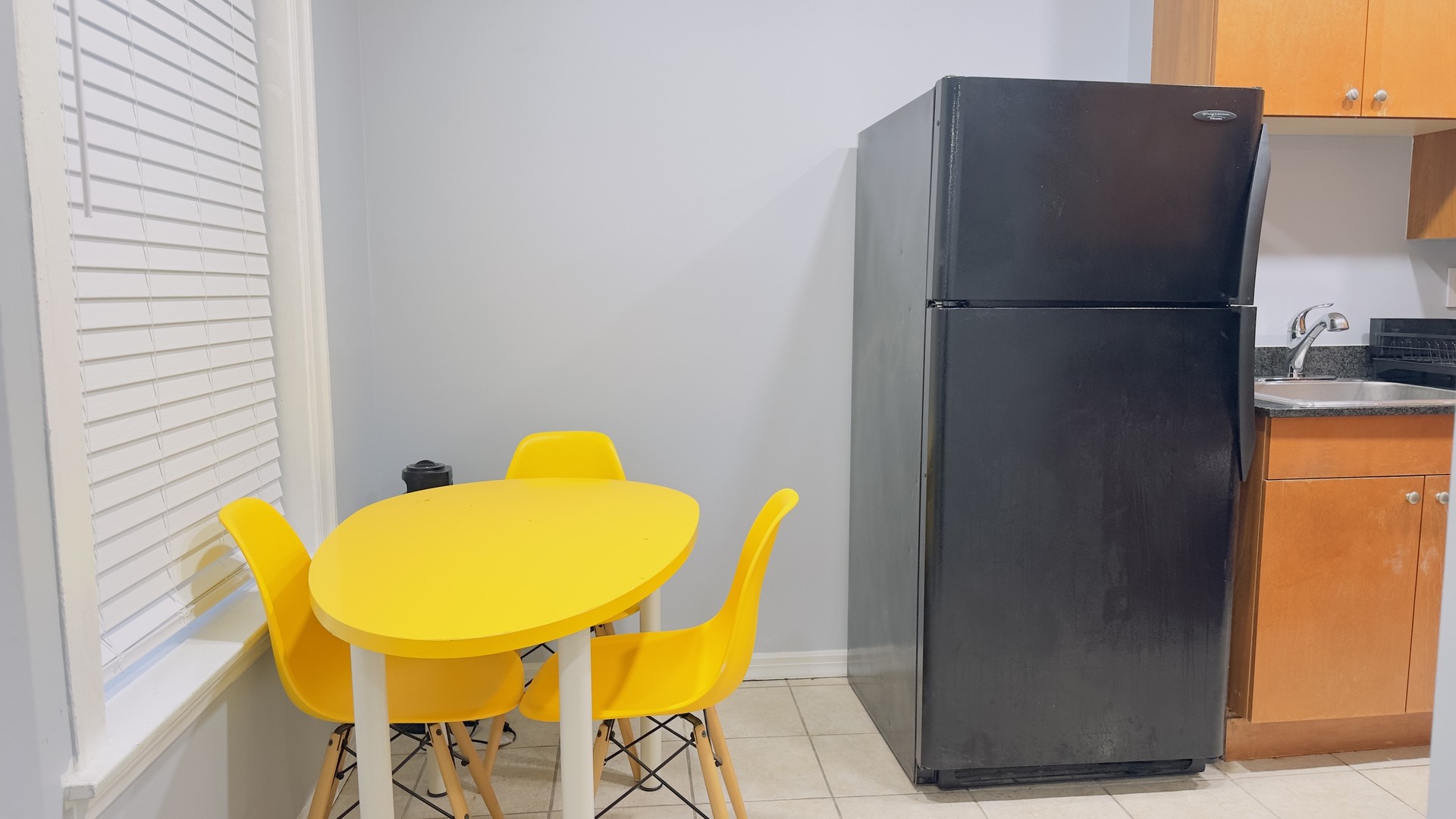 1411 West Farwell Avenue, Unit E2 Chicago, IL 60626 - Photo 11 of 27 a blue kitchen with a sink and a refrigerator