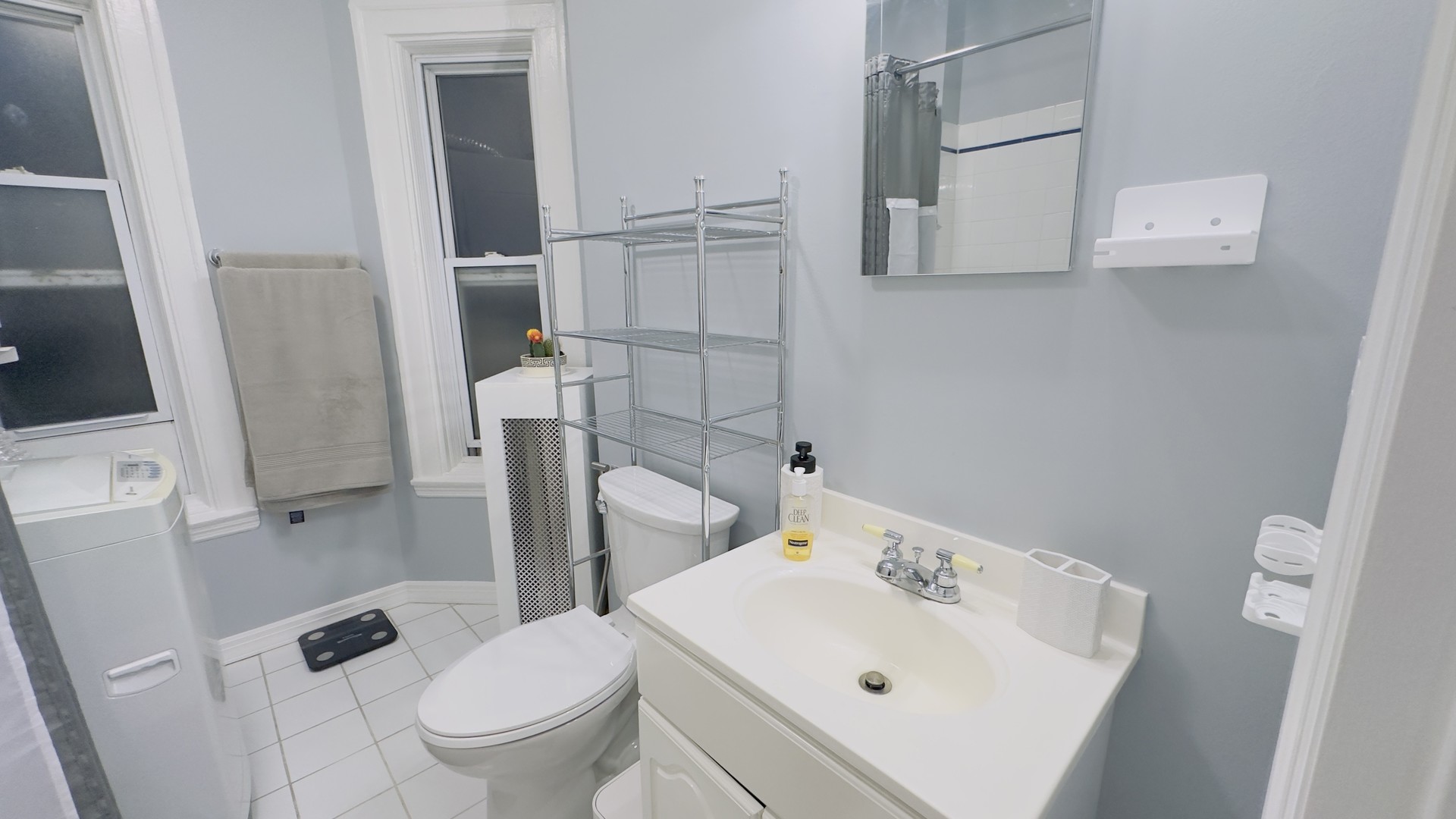 1411 West Farwell Avenue, Unit E2 Chicago, IL 60626 - Photo 26 of 27 a white toilet sitting next to a bathroom sink
