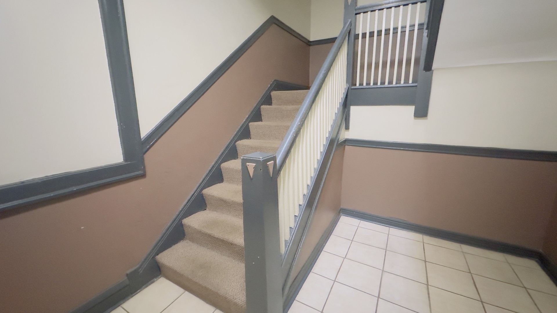1411 West Farwell Avenue, Unit E2 Chicago, IL 60626 - Photo 4 of 27 a view of staircase with white walls and railing