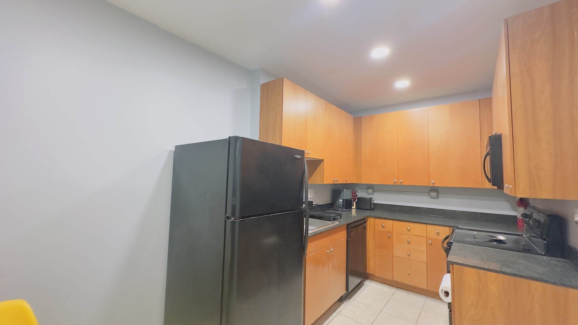 1411 West Farwell Avenue, Unit E2 Chicago, IL 60626 - Photo 8 of 27 a kitchen with stainless steel appliances granite countertop a refrigerator and a sink