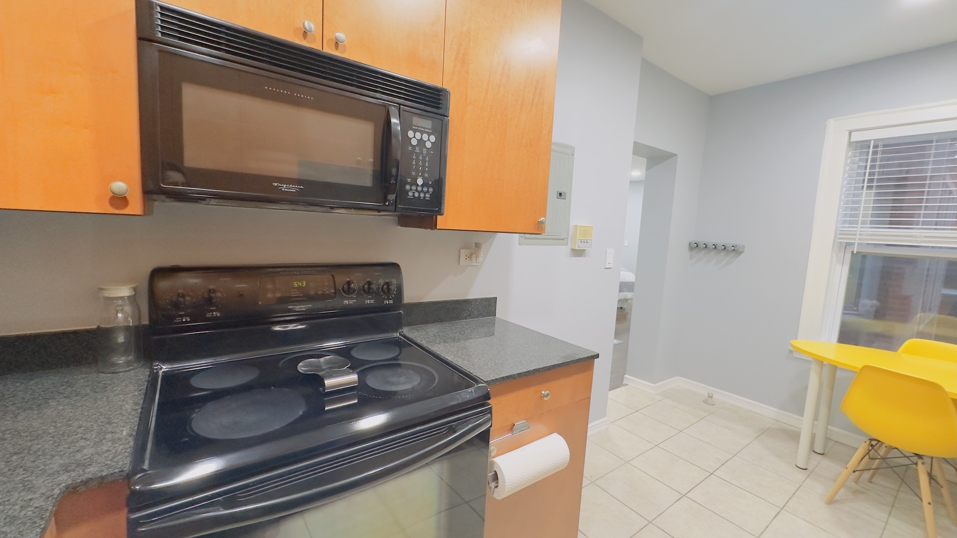 1411 West Farwell Avenue, Unit E2 Chicago, IL 60626 - Photo 10 of 27 a kitchen with a stove and a microwave