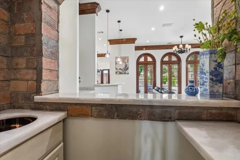a kitchen with a sink a stove cabinets and a counter top space
