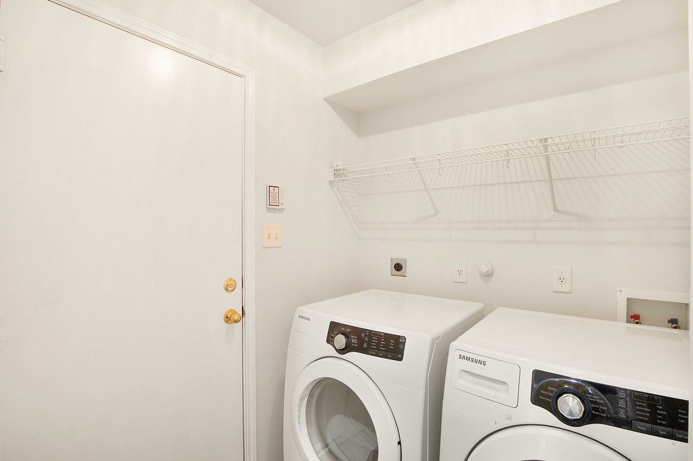 3310 Blue Ridge Drive Round Rock, TX 78681 - Photo 10 of 13 Functional utility space with modern washer and dryer, plus convenient wall-mounted shelving.