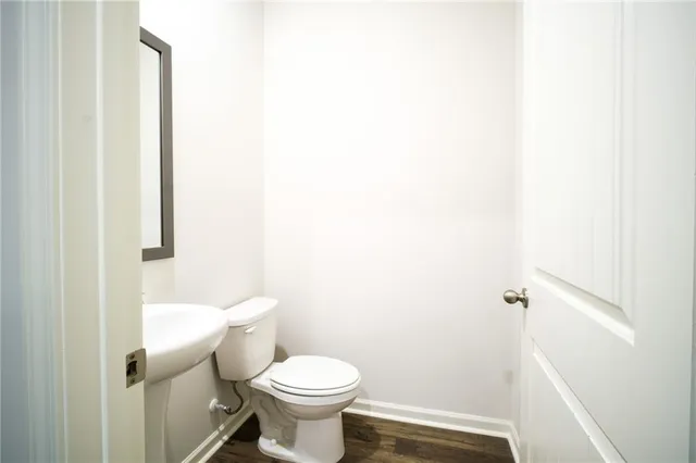 a white toilet sitting next to a white cabinet