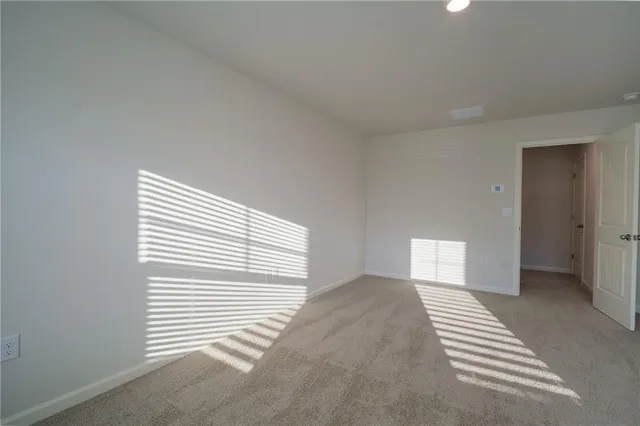 a view of a livingroom with wooden floor and a window