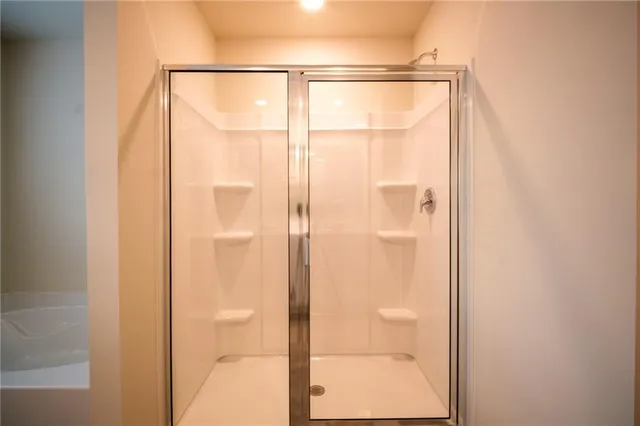 a bathroom with a glass shower door