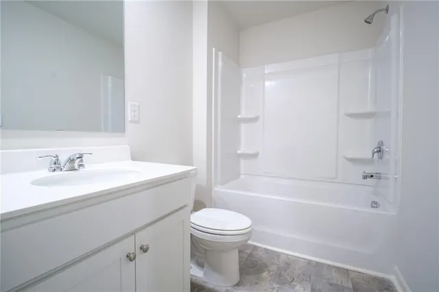 a bathroom with a sink toilet and mirror