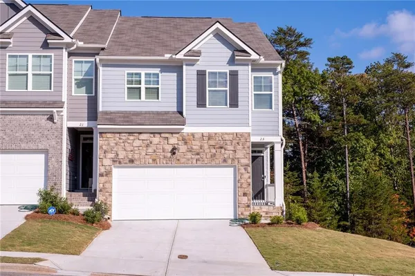 a front view of a house with a yard and garage