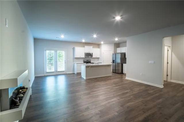 a view of kitchen with cabinets and wooden floor